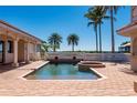Private pool with brick patio, surrounded by lush landscaping and offering serene waterfront views and privacy at 17557 Ohara Dr, Port Charlotte, FL 33948