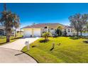 Charming single-story home with a three-car garage and a beautifully landscaped front yard at 24337 Contra Costa Ln, Punta Gorda, FL 33955