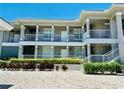 Coastal condo building featuring well-maintained landscaping and multiple levels with balconies at 3311 Wood Thrush Dr # 111, Punta Gorda, FL 33950