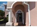 Close-up of a front door featuring brick pavers and a decorative pillar at 5275 Layton Dr, Venice, FL 34293