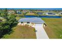 Aerial view of a charming single-story home with canal views and a two-car garage at 102 Annapolis Ln, Rotonda West, FL 33947