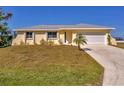Charming single-story home with a well-manicured lawn and a two-car garage at 102 Annapolis Ln, Rotonda West, FL 33947