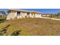 Charming single-story home with a well-manicured lawn and a two-car garage at 102 Annapolis Ln, Rotonda West, FL 33947