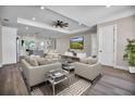 Spacious living room with stylish furniture, a ceiling fan, and a modern entertainment center at 16305 Branco Dr, Punta Gorda, FL 33955