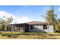 View of the home's screened-in back porch with a view of the backyard and blue sky at 2784 Dode Ave, North Port, FL 34288