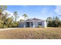 Charming single-story home with a well-maintained lawn and lush landscaping around the property at 2784 Dode Ave, North Port, FL 34288