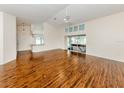 Open-concept living area with wood floors, vaulted ceilings, and access to the lanai and jacuzzi at 3341 Briant St, North Port, FL 34287