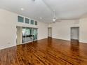 Bright and spacious living room with hardwood floors and large windows, including a sliding glass door at 3341 Briant St, North Port, FL 34287