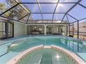 Inviting screened-in pool area with spa and ample space for relaxing and entertaining outdoors at 3341 Briant St, North Port, FL 34287