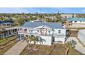 Bright waterfront home with a metal roof, balconies, covered parking, and easy canal access at 4297 Nettle Rd, Port Charlotte, FL 33953