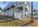 Elevated waterfront home featuring a convenient lift, covered parking and boat trailer at 4297 Nettle Rd, Port Charlotte, FL 33953