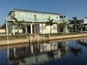 Waterfront home with a metal roof, dock, and outdoor space perfect for enjoying waterfront living at 4297 Nettle Rd, Port Charlotte, FL 33953