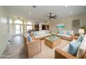 Bright living room with neutral walls, wicker furniture and beachy decor at 8242 Lakeside Dr, Englewood, FL 34224