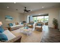 Bright living room with neutral walls, wicker furniture and decor at 8242 Lakeside Dr, Englewood, FL 34224