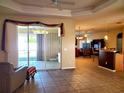 Bright living space showcases sliding glass doors, leading to the patio, and adjacent kitchen area at 1057 Staley St, Port Charlotte, FL 33952