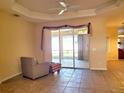 Open living area boasts sliding glass doors to the screened lanai, and recessed lighting at 1057 Staley St, Port Charlotte, FL 33952