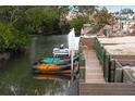 Private waterfront dock with kayaks and boat, providing direct access to the serene canal waters at 1845 Edison Dr, Englewood, FL 34224