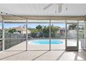 Screened-in lanai showcases a sparkling pool, providing a serene outdoor living space with backyard views at 1845 Edison Dr, Englewood, FL 34224