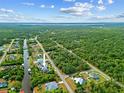 Gorgeous aerial view of a waterfront property with lush landscaping, and a private dock at 472 Eppinger Dr, Port Charlotte, FL 33953