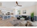 Spacious living room and kitchen area feature tiled floors, ceiling fan, breakfast bar, and stainless appliances at 14091 Heritage Landing Blvd # 121, Punta Gorda, FL 33955