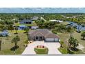 Stunning single-Gathering home with circular driveway, lush landscaping and screened-in lanai at 4122 Library St, Port Charlotte, FL 33948