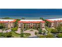 A beautiful waterfront condo complex with red tile roofs and manicured landscaping provides luxurious coastal living at 89 Vivante Blvd # 205, Punta Gorda, FL 33950
