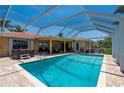 Large screened pool featuring brick-paved patio and jacuzzi at 805 Brenda Ct, Punta Gorda, FL 33950
