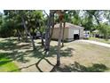 Large outbuilding with an RV parked alongside on a well-manicured, treed lot at 14057 Maxwell Ave, Port Charlotte, FL 33953