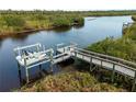 This stunning view of a private wooden dock on the water is the perfect place to relax or launch your boat at 700 N River Rd, Venice, FL 34293