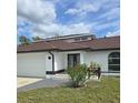 Charming one-story home with a well-manicured lawn, double door entry, and an attached two car garage at 1438 Navigator Rd, Punta Gorda, FL 33983