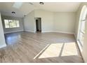Spacious living room with light hardwood flooring, a large window, and high ceilings with skylights at 1438 Navigator Rd, Punta Gorda, FL 33983