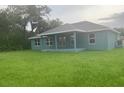 Spacious backyard with lush lawn and covered patio, great for outdoor relaxation at 4063 Conestoga St, Port Charlotte, FL 33948