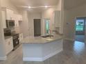 Modern kitchen featuring granite counters, stainless steel appliances, and white cabinetry at 4063 Conestoga St, Port Charlotte, FL 33948