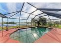 Screened in pool overlooking beautiful lake and outdoor landscape at 1115 Venture Ct, Punta Gorda, FL 33983