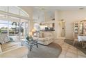 Bright living room featuring high ceilings, tile flooring, comfortable seating and a glass sliding door to the pool at 5430 Almar Dr, Punta Gorda, FL 33950