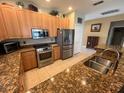 Well-lit kitchen features stainless steel appliances and granite countertops at 24157 Green Heron Dr # 27, Punta Gorda, FL 33980
