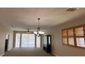 Spacious living room features high ceilings, large windows, and a chandelier at 24157 Green Heron Dr # 27, Punta Gorda, FL 33980