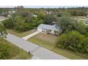 Charming single-story home with a well-manicured lawn and mature trees at 5452 Montego Ln, Port Charlotte, FL 33981