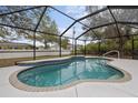 Inviting in-ground pool inside a screened enclosure offers a great place to relax at 5452 Montego Ln, Port Charlotte, FL 33981