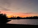 Scenic sunset view overlooking the tranquil lake with trees in silhouette at 2275 Kenya Ln, Punta Gorda, FL 33983