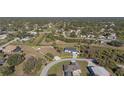An aerial shot shows a cozy home with a long driveway and well-maintained yard outlined in yellow at 2668 Clovelon St, North Port, FL 34291