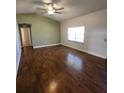 Bright living room with ceiling fan and natural light enhances the open space at 18085 Wintergarden Ave, Port Charlotte, FL 33948