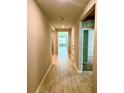 Inviting hallway with neutral paint, tile flooring, and views into the living spaces with natural light at 9525 Turtle Grass Cir, Punta Gorda, FL 33950