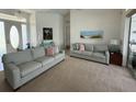 Bright living room featuring neutral tones, comfortable couches, and natural light, creating an inviting atmosphere at 5028 San Massimo Dr, Punta Gorda, FL 33950