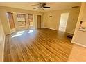 Bright living room with light hardwood floors, ceiling fan, and sunny bay window at 18938 Ayrshire Cir, Port Charlotte, FL 33948