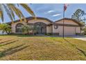 Inviting single-Gathering home with well-manicured lawn, tropical plants and a two-car garage at 23239 Stelling Ave, Punta Gorda, FL 33980