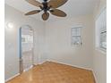 Cozy room with hardwood floors, arched entryway and natural light from the window with a ceiling fan at 28482 Coco Palm Dr, Punta Gorda, FL 33982