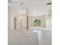 Bright and airy living room features tile and carpet flooring, high ceilings, and large windows at 3896 Slayton Ave, North Port, FL 34286