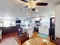 Bright open floor plan seamlessly combines a modern white kitchen with the adjacent living area at 1311 Abscott St, Port Charlotte, FL 33952