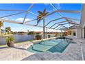Screened-in pool area with waterfront views, offering a private oasis for relaxation and entertainment at 3415 Tripoli Blvd, Punta Gorda, FL 33950